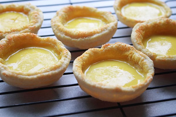 Chinese egg tarts on a cooling rack
